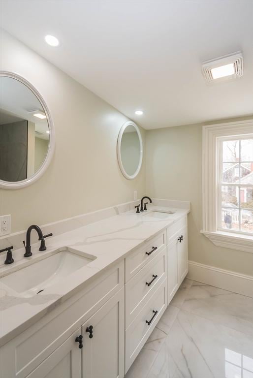 full bathroom with a sink, marble finish floor, and double vanity