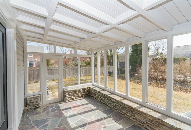 unfurnished sunroom with beam ceiling and coffered ceiling