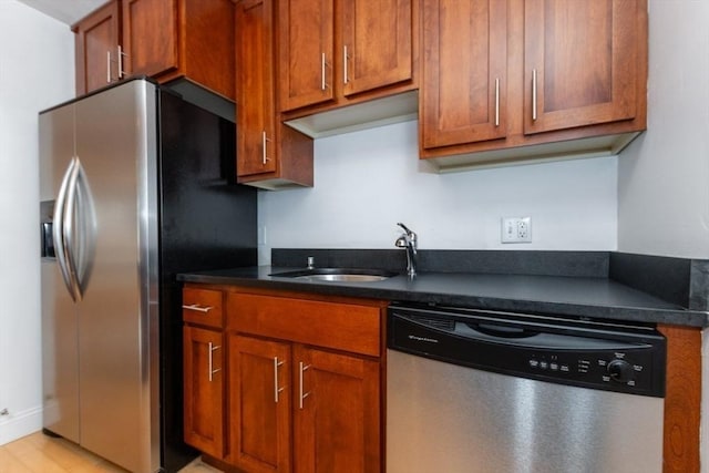 115 Highland Ave Unit 11, Somerville, MA 02143 - kitchen with stainless steel appliances, a sink, and brown cabinetry