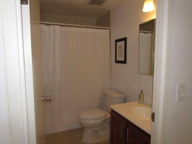 115 Highland Ave Unit 11, Somerville, MA 02143 - bathroom featuring vanity, toilet, and curtained shower