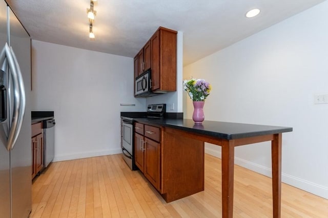 115 Highland Ave Unit 11, Somerville, MA 02143 - kitchen with appliances with stainless steel finishes, light wood-style flooring, dark countertops, baseboards, and recessed lighting