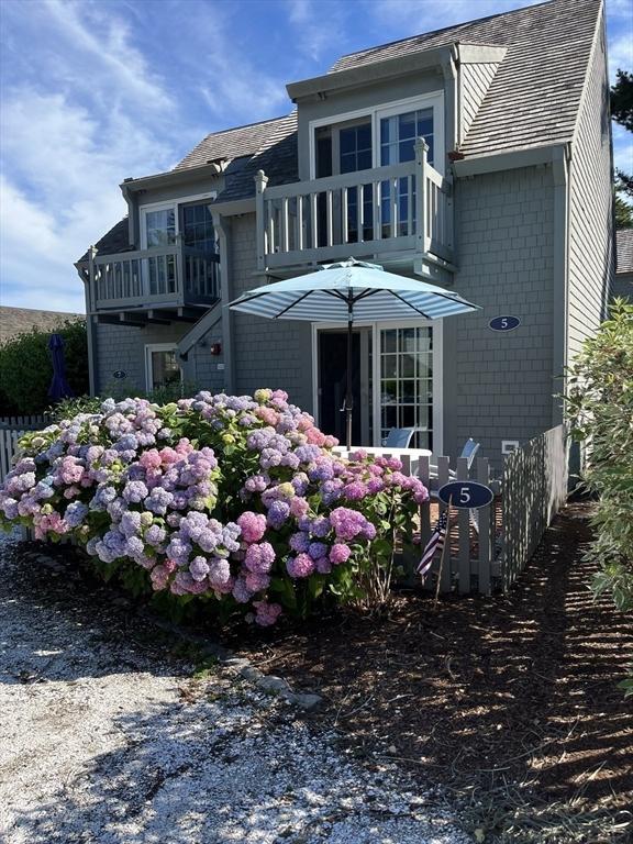 5 Hydrangea Ln Unit 5, Mashpee, MA 02649 - back of house with a balcony, a shingled roof, and brick siding