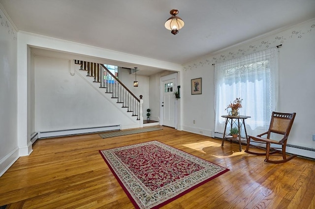 154 N Maple St, Northampton, MA 01062 - entrance foyer featuring baseboard heating, stairway, healthy amount of natural light, wood finished floors, and crown molding