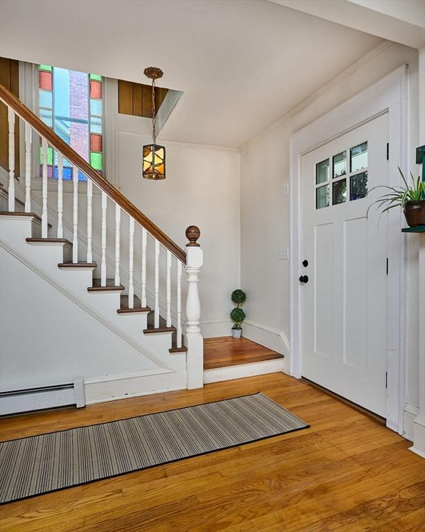 154 N Maple St, Northampton, MA 01062 - foyer with wood finished floors, baseboard heating, and stairway