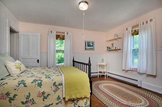 154 N Maple St, Northampton, MA 01062 - bedroom with multiple windows, a baseboard radiator, wood finished floors, and wainscoting