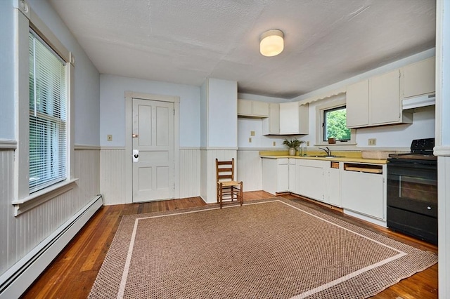 154 N Maple St, Northampton, MA 01062 - kitchen featuring a baseboard radiator, black electric range oven, white dishwasher, under cabinet range hood, and dark wood finished floors