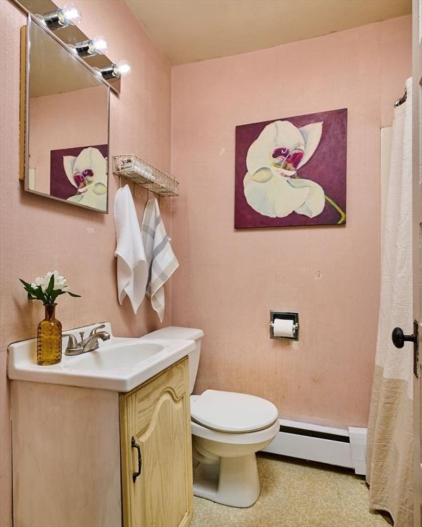 154 N Maple St, Northampton, MA 01062 - full bathroom featuring a baseboard radiator, vanity, and a shower with curtain