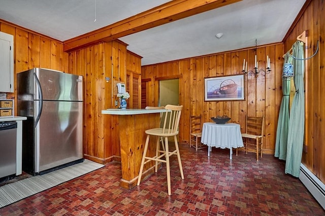 154 N Maple St, Northampton, MA 01062 - kitchen with stainless steel appliances, baseboard heating, wooden walls, brown cabinets, and brick patterned floors