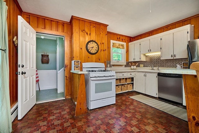 154 N Maple St, Northampton, MA 01062 - kitchen featuring stainless steel dishwasher, white range with gas cooktop, light countertops, wooden walls, and brick patterned flooring