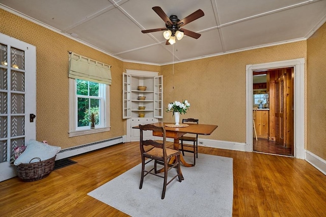 154 N Maple St, Northampton, MA 01062 - dining space with a baseboard heating unit, wood finished floors, a ceiling fan, and ornamental molding