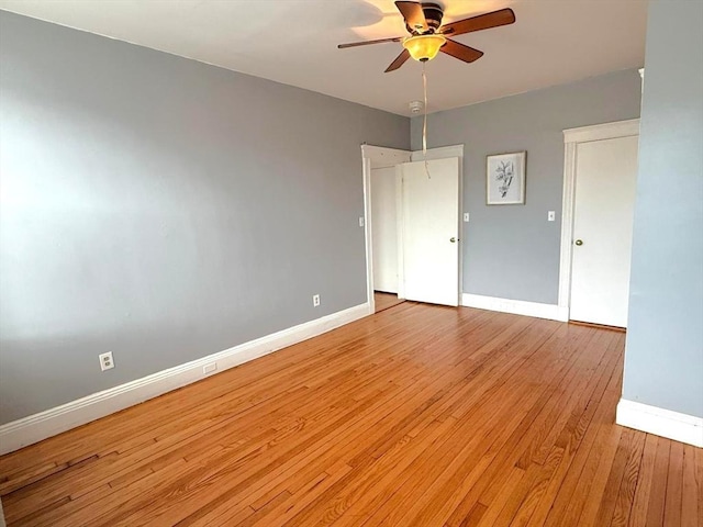 unfurnished bedroom with baseboards, light wood-style flooring, and a ceiling fan