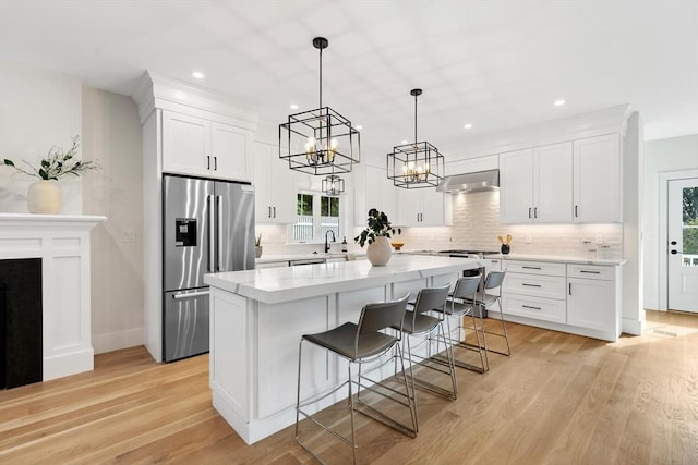 kitchen featuring white cabinetry, stainless steel fridge with ice dispenser, and a kitchen island