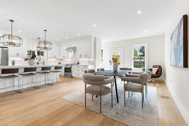 dining room featuring a chandelier and light wood-type flooring