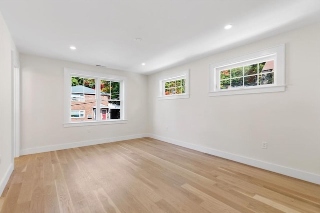 empty room with light hardwood / wood-style flooring