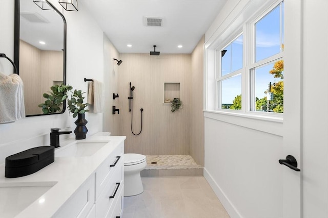 bathroom featuring vanity, toilet, and walk in shower