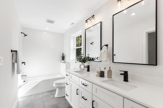 full bathroom featuring vanity, toilet, and  shower combination