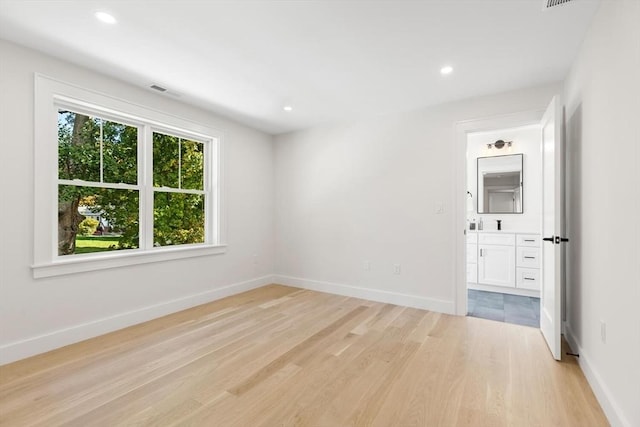 spare room featuring light wood-type flooring