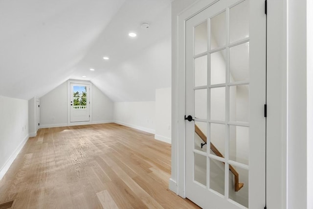 bonus room with light hardwood / wood-style floors and lofted ceiling