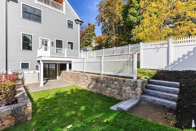 back of property featuring a yard and a patio