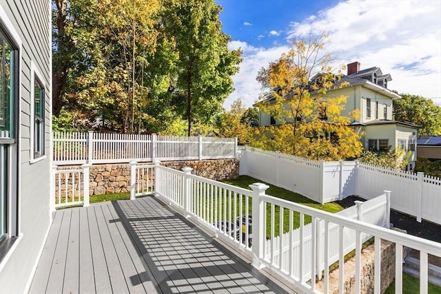 wooden terrace with a lawn