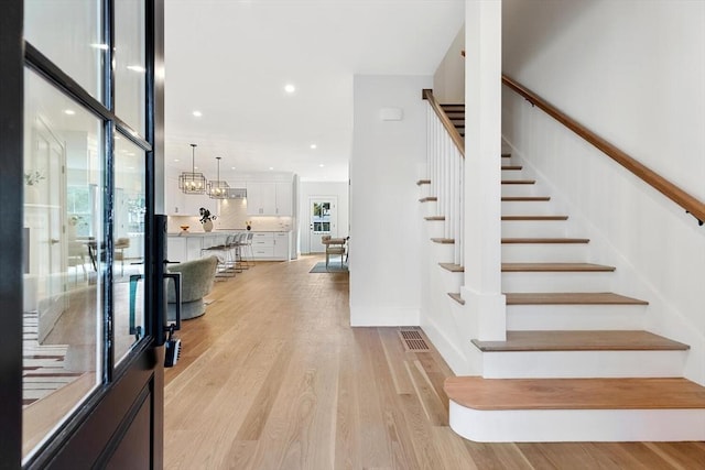 stairs with hardwood / wood-style floors