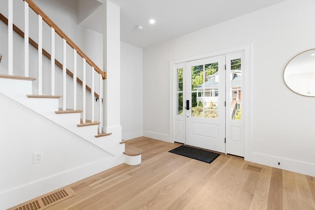 foyer entrance with light wood-type flooring