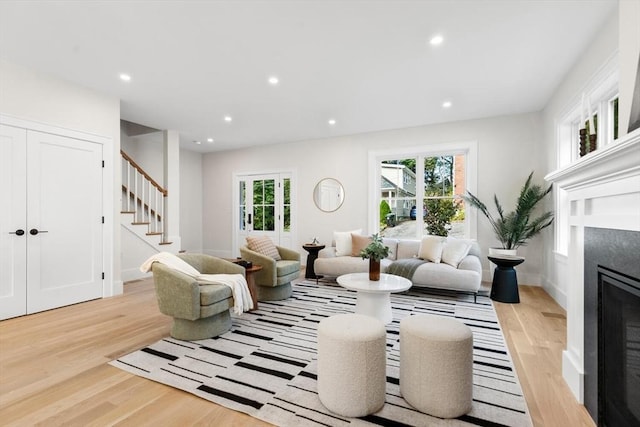 living room featuring a healthy amount of sunlight and light hardwood / wood-style flooring