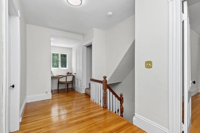 781 Highland Ave, Needham, MA 02494 - corridor featuring light wood-type flooring, an upstairs landing, a desk, and baseboards