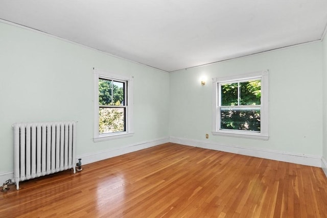 781 Highland Ave, Needham, MA 02494 - unfurnished room featuring radiator, light wood finished floors, and baseboards