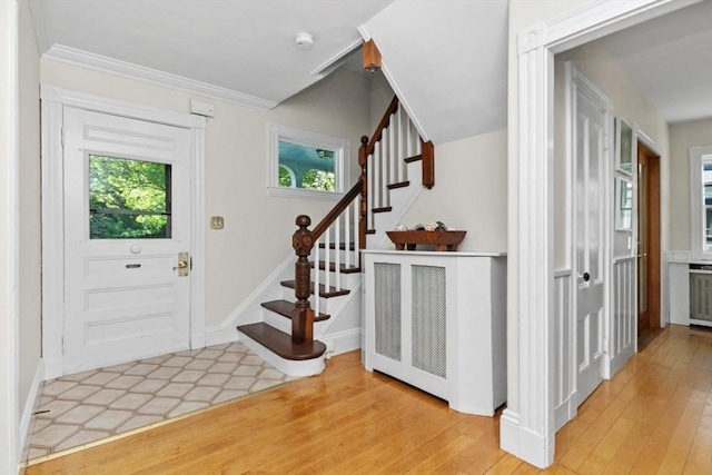 781 Highland Ave, Needham, MA 02494 - foyer featuring stairway, plenty of natural light, light wood-type flooring, and ornamental molding