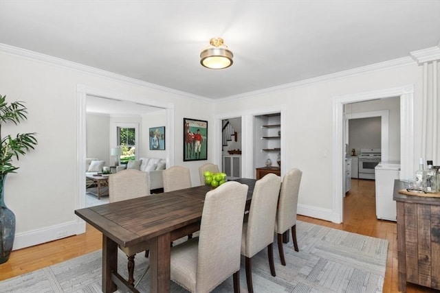 781 Highland Ave, Needham, MA 02494 - dining area with light wood-style floors, baseboards, crown molding, and built in shelves