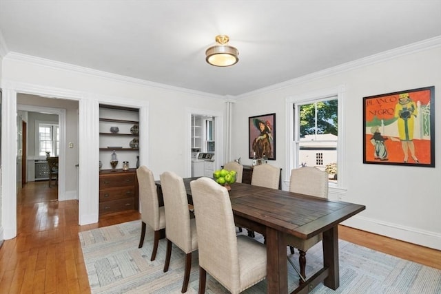 781 Highland Ave, Needham, MA 02494 - dining room featuring ornamental molding, light wood-style floors, baseboards, and separate washer and dryer