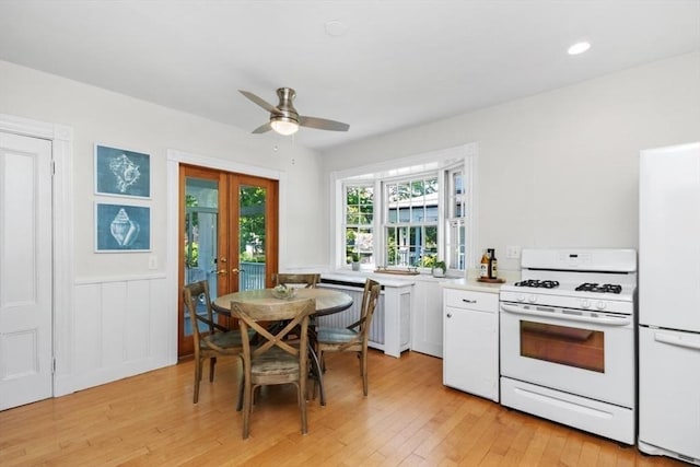 781 Highland Ave, Needham, MA 02494 - kitchen featuring white appliances, french doors, white cabinets, light wood-type flooring, and a wainscoted wall