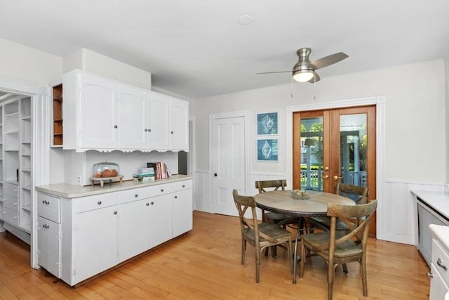 781 Highland Ave, Needham, MA 02494 - kitchen featuring light wood-style floors, light countertops, white cabinets, french doors, and a ceiling fan