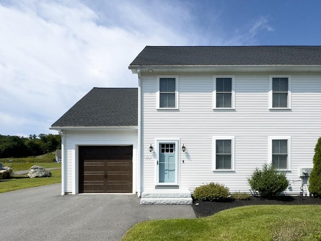 colonial home with a garage and a front yard