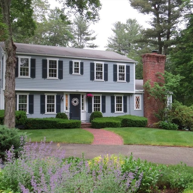 15 Thoreau Rd, Acton, MA 01720 - colonial house featuring a chimney and a front lawn
