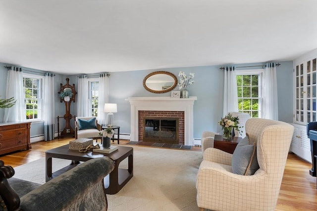 15 Thoreau Rd, Acton, MA 01720 - living room featuring a baseboard heating unit, light wood finished floors, and a brick fireplace