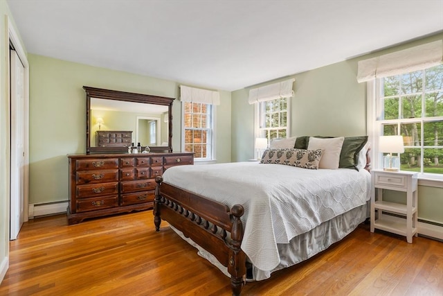 15 Thoreau Rd, Acton, MA 01720 - bedroom with baseboard heating, wood finished floors, and multiple windows
