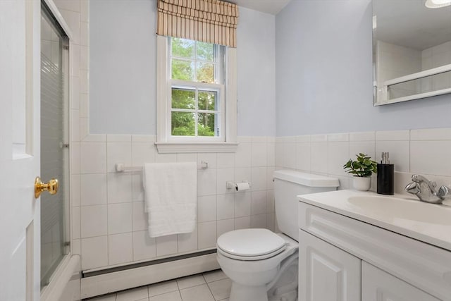 15 Thoreau Rd, Acton, MA 01720 - bathroom with a baseboard heating unit, an enclosed shower, tile patterned floors, vanity, and tile walls