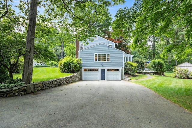 15 Thoreau Rd, Acton, MA 01720 - view of property exterior with driveway, a garage, a yard, and a chimney