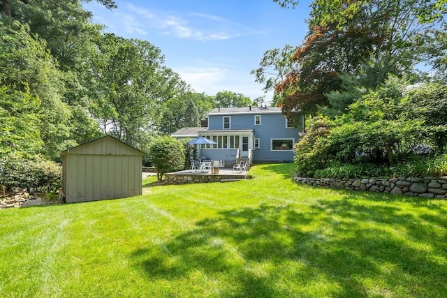 15 Thoreau Rd, Acton, MA 01720 - view of green lawn featuring a storage shed and a patio area