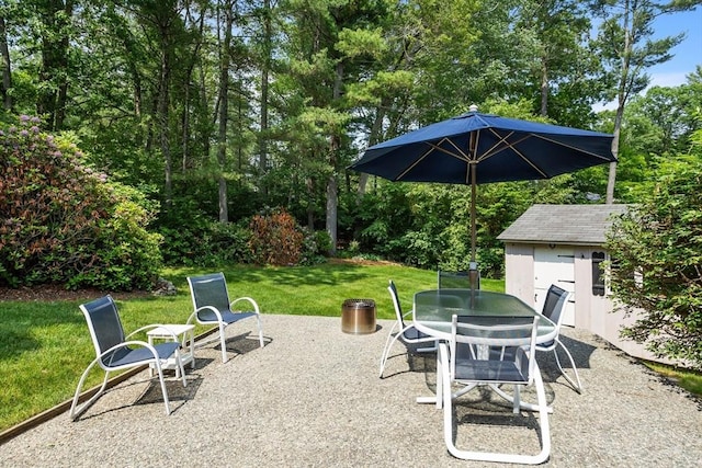 15 Thoreau Rd, Acton, MA 01720 - view of patio with outdoor dining space, a storage unit, and view of scattered trees