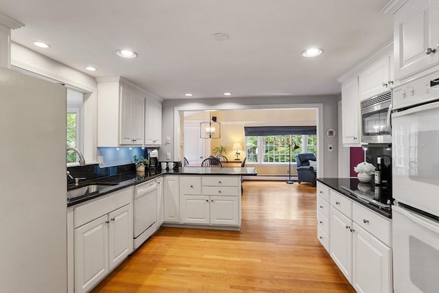 15 Thoreau Rd, Acton, MA 01720 - kitchen featuring white appliances, light wood finished floors, white cabinetry, a peninsula, and recessed lighting