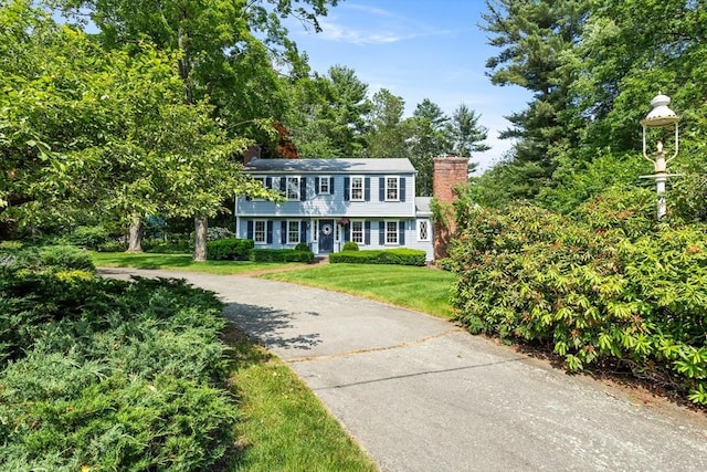 15 Thoreau Rd, Acton, MA 01720 - view of front of property featuring a chimney and a front lawn
