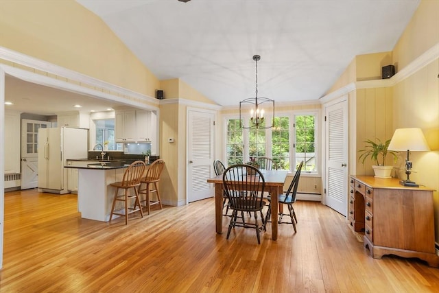 15 Thoreau Rd, Acton, MA 01720 - dining area featuring radiator, a chandelier, lofted ceiling, light wood finished floors, and a baseboard heating unit