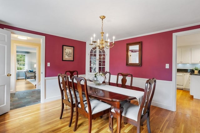 15 Thoreau Rd, Acton, MA 01720 - dining space with a chandelier, light wood finished floors, and a wainscoted wall