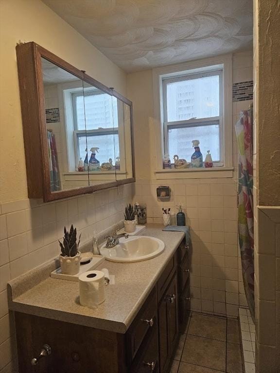 192 Chestnut St, Chelsea, MA 02150 - bathroom with tile walls, vanity, and tile patterned flooring