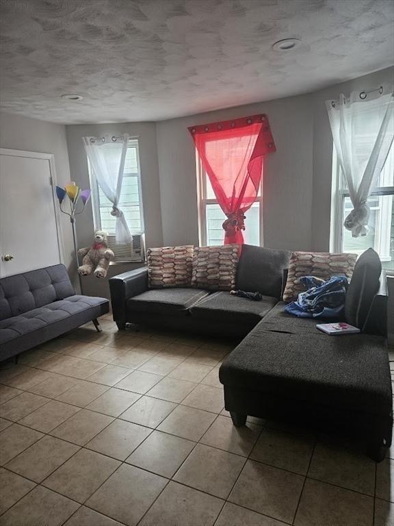 192 Chestnut St, Chelsea, MA 02150 - living area featuring tile patterned floors and a textured ceiling