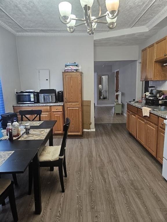 192 Chestnut St, Chelsea, MA 02150 - dining space with wood finished floors and a chandelier