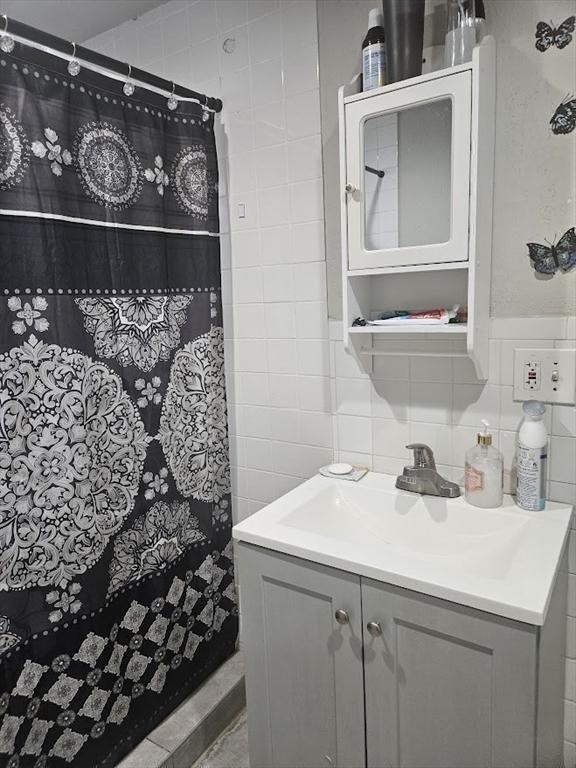 192 Chestnut St, Chelsea, MA 02150 - bathroom featuring tile walls, vanity, and a shower with shower curtain